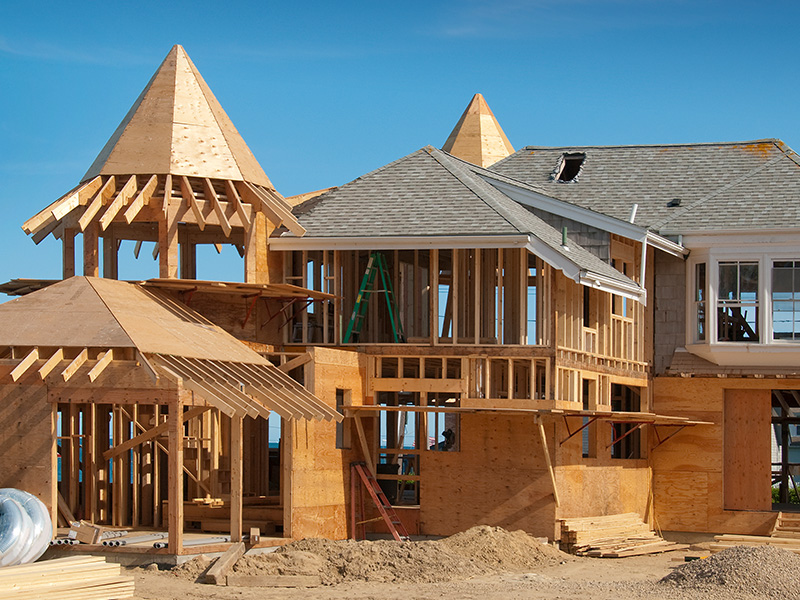 Home addition under construction with plywood structure half finished