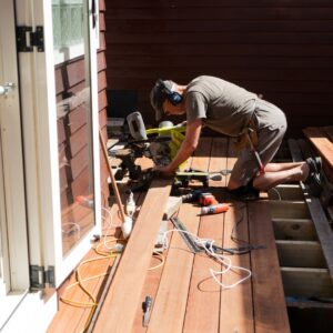 man building deck on residential property