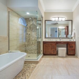 a new bathroom with a glass shower an wooden vanity