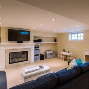 a basement with a tv and couch