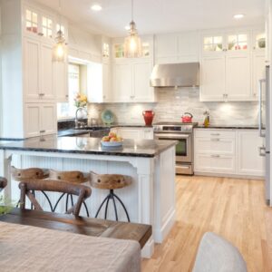 a new kitchen with white cabinets and stone countertops